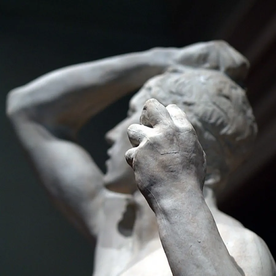 A sculpted clenched fist raised in strength.